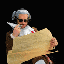 a man in a suit and sunglasses is holding a piece of paper