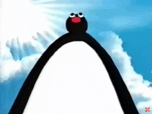 a black and white penguin with a red nose is standing on top of a white mountain