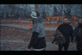 a man in a helmet talks to two other men