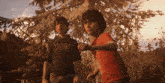 two boys are standing next to each other and one of them has a shirt that says ' rock ' on it