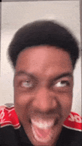 a close up of a man 's face with his mouth open .