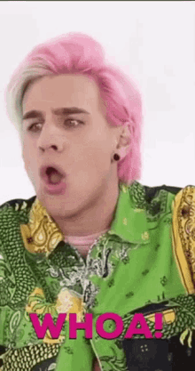 a man with pink hair is wearing a green and yellow shirt .