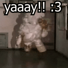a man in a white suit is standing in a dark room with the words yaaay !!! 3 above him