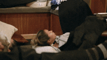 a woman laying on the floor with a bandage on her eyes