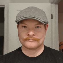 a man with a mustache wearing a hat