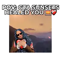 a man wrapped in an american flag holding a heart with the words " pov gta sunsets healed you " above him
