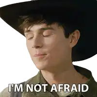 a young man wearing a cowboy hat says " i 'm not afraid "