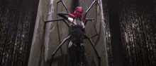 a woman in a spider costume stands in front of a building