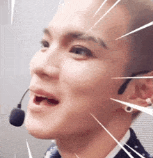 a close up of a man wearing a microphone and earrings