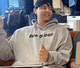 a man is wearing a hoodie that says halloween on it