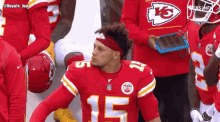 a man wearing a chiefs jersey with the number 15 on it