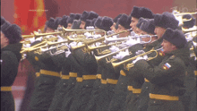 a group of men in military uniforms are playing trumpets in front of a sign that says прямой зонр