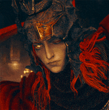 a man with long red hair wearing a helmet