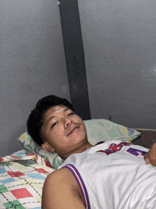 a man laying on a bed wearing a jersey that says ' nba '