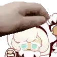 a cookie run character with a beard is being touched by a person 's hand .