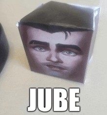 a cube with a man 's face and the word jube