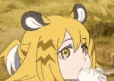 a close up of a cartoon girl with yellow hair and ears eating something .