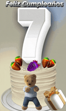 a teddy bear is standing next to a birthday cake with the number 7 on top