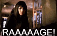 a woman is standing in front of a sign that says raaaaage .
