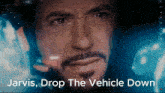 a close up of a man 's face with jarvis drop the vehicle down written below it