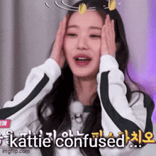 a woman is covering her face with her hands and the words katie confused are written on the bottom .