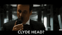 a man in a tuxedo and tie is standing in a hallway and says i do n't know .