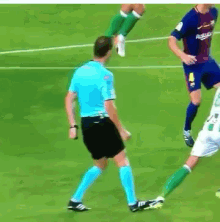 a man in a blue shirt with the number 8 on it stands on a soccer field