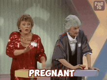 two women standing next to each other with the word pregnant written on the screen