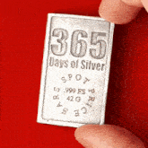 a person is holding a piece of silver that says 365 days of silver on it