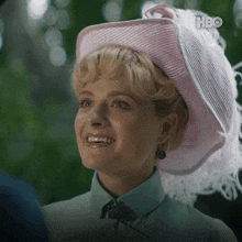 a close up of a woman wearing a pink hat with the hbo logo in the corner