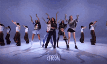a group of women are dancing in front of a blue background with the word choom on it
