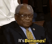 a man in a suit and tie says it 's bananas in yellow letters