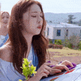 a girl with a flower in her hand looks at a map