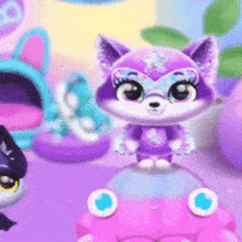 a purple stuffed animal is sitting on top of a pink bubble .