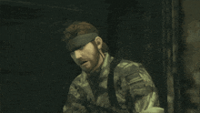 a man with a beard is wearing a camouflage uniform