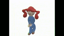 a stuffed doll with red hair and a blue outfit