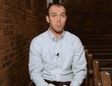 a man in a white shirt with a microphone on his shirt