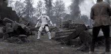 a storm trooper is standing in front of a man in a brown jacket .