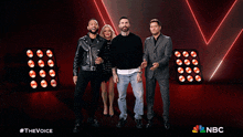 a woman in a black and white polka dot dress is dancing with a man in a leather jacket and another man in jeans