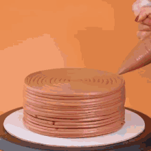a chocolate cake is sitting on a black plate with a white circle around it