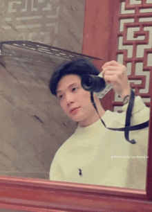 a man taking a picture of himself in a mirror