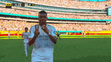 a soccer player wearing an emirates fly better jersey shows a peace sign