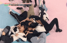 a group of people laying on the floor with a sticker that says ' aroi ' on the bottom