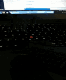 a blurry picture of a computer screen with a red light on the bottom right