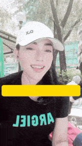 a woman wearing a white hat and a t-shirt that says j3i3a