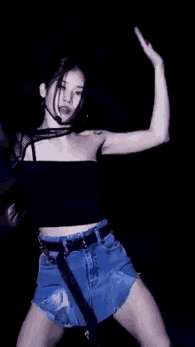a woman with a heart tattoo on her shoulder is dancing on a stage .