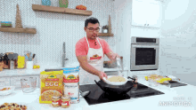 a man is cooking in a kitchen with a bag of egg noodles in the background