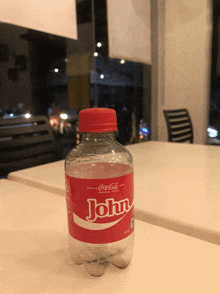 a bottle of coca cola with the name john on the label