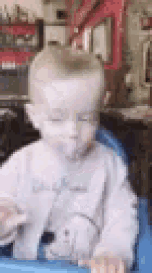 a baby in a high chair with a pacifier in his mouth .