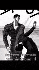 a man in a striped shirt is standing next to another man who is laying down